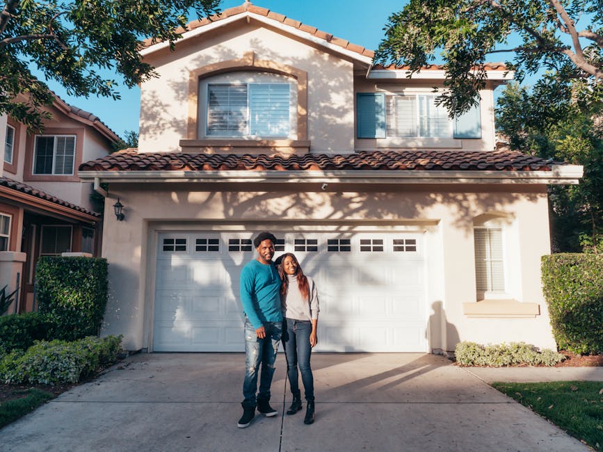 Homeowner couple in front of their house